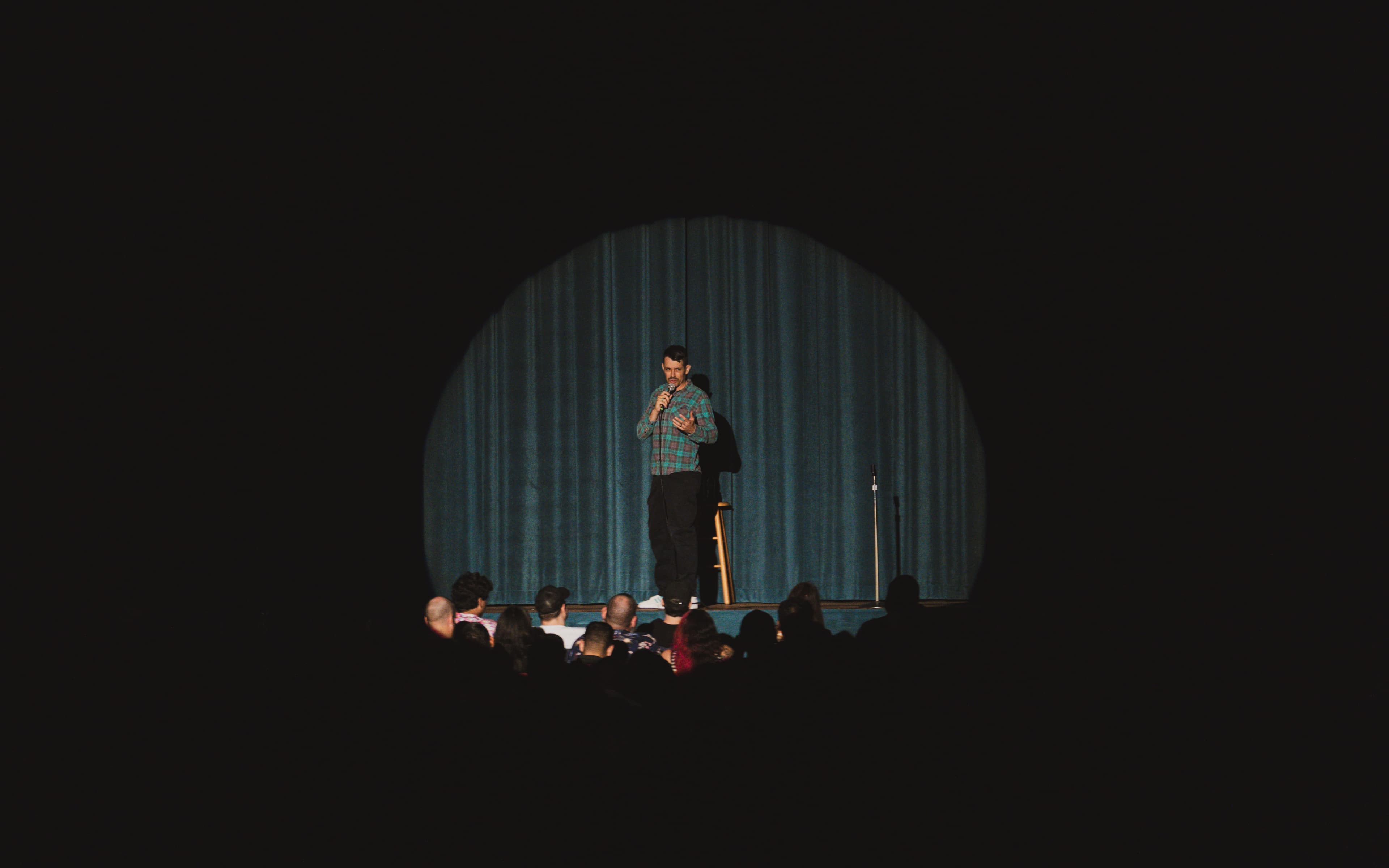 Nate Craig in the spotlight on a theater stage