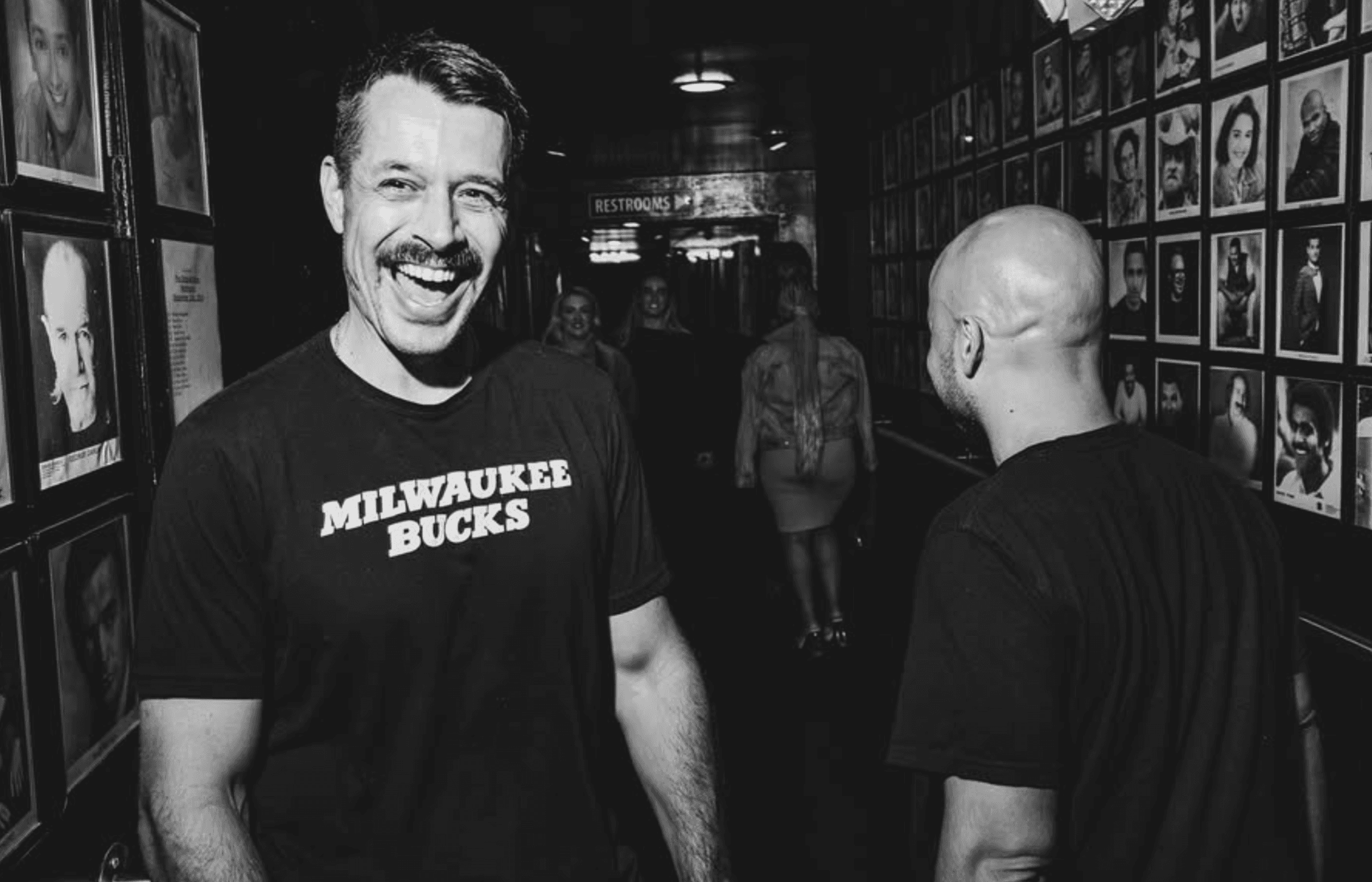 Nate Craig laughing backstage at a comedy club